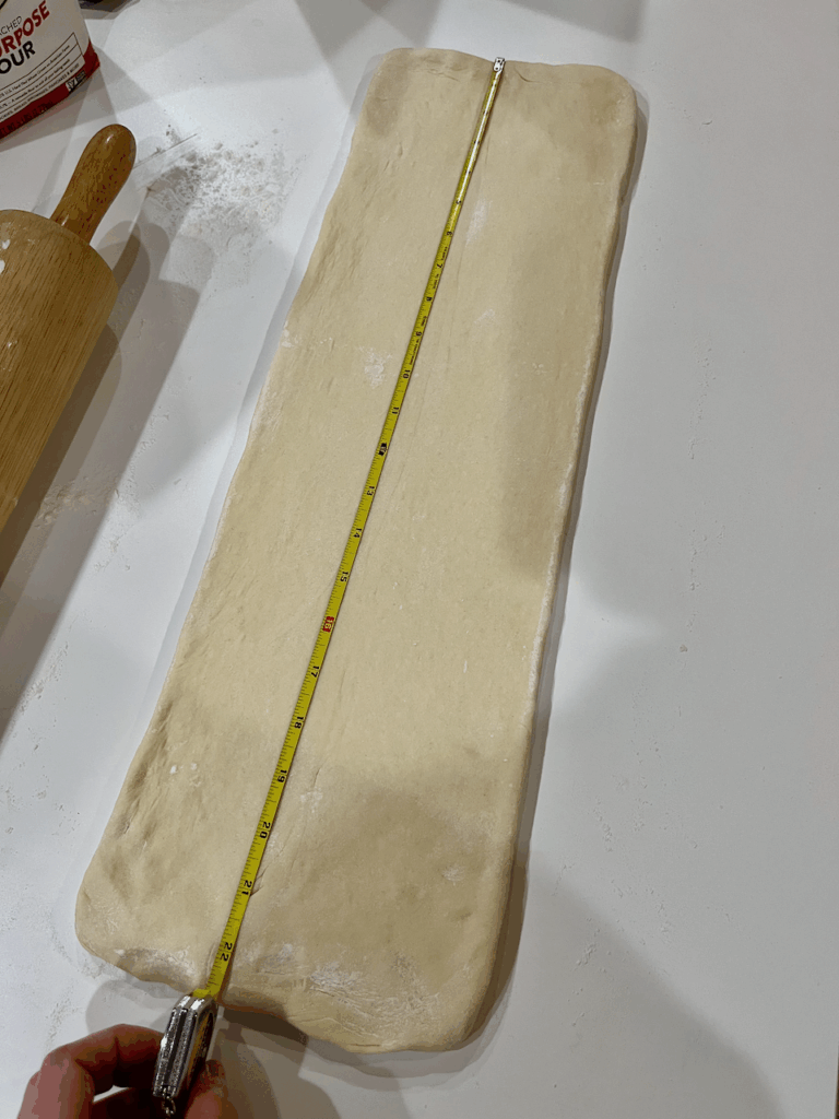 A 22" by 7" rectangle of dough being laminated